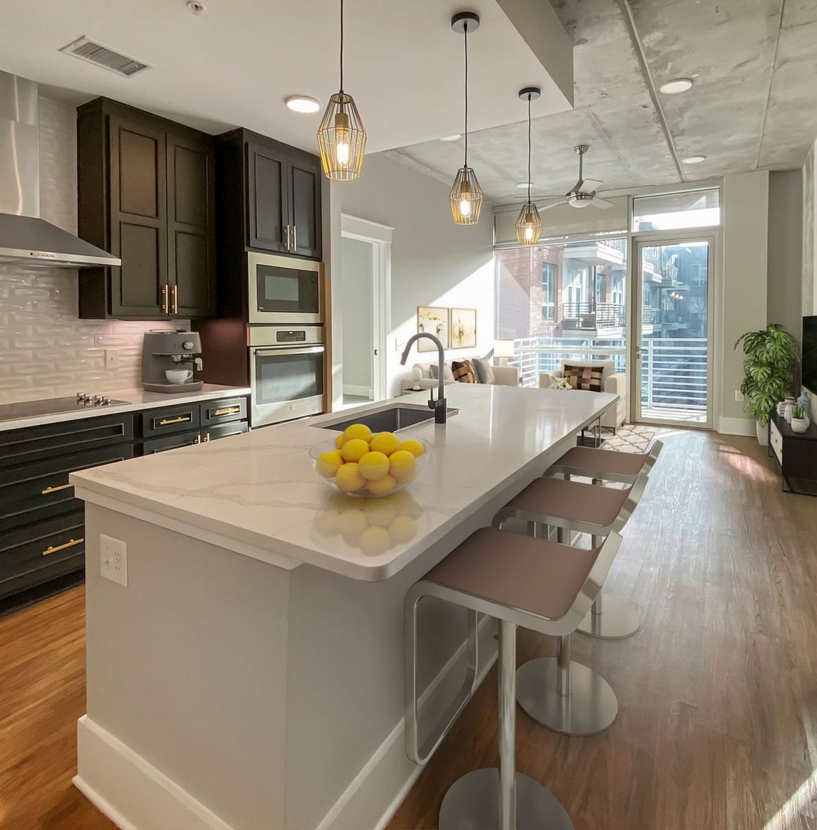 Providence Row apartment kitchen with island, stainless steel appliances, and beautiful finishes