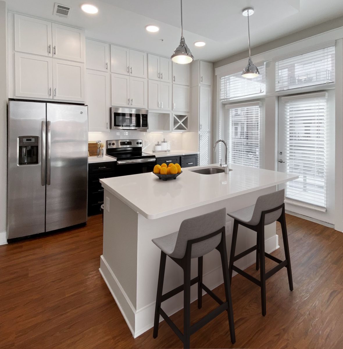 Providence Row apartment kitchen with island, stainless steel appliances, and beautiful finishes