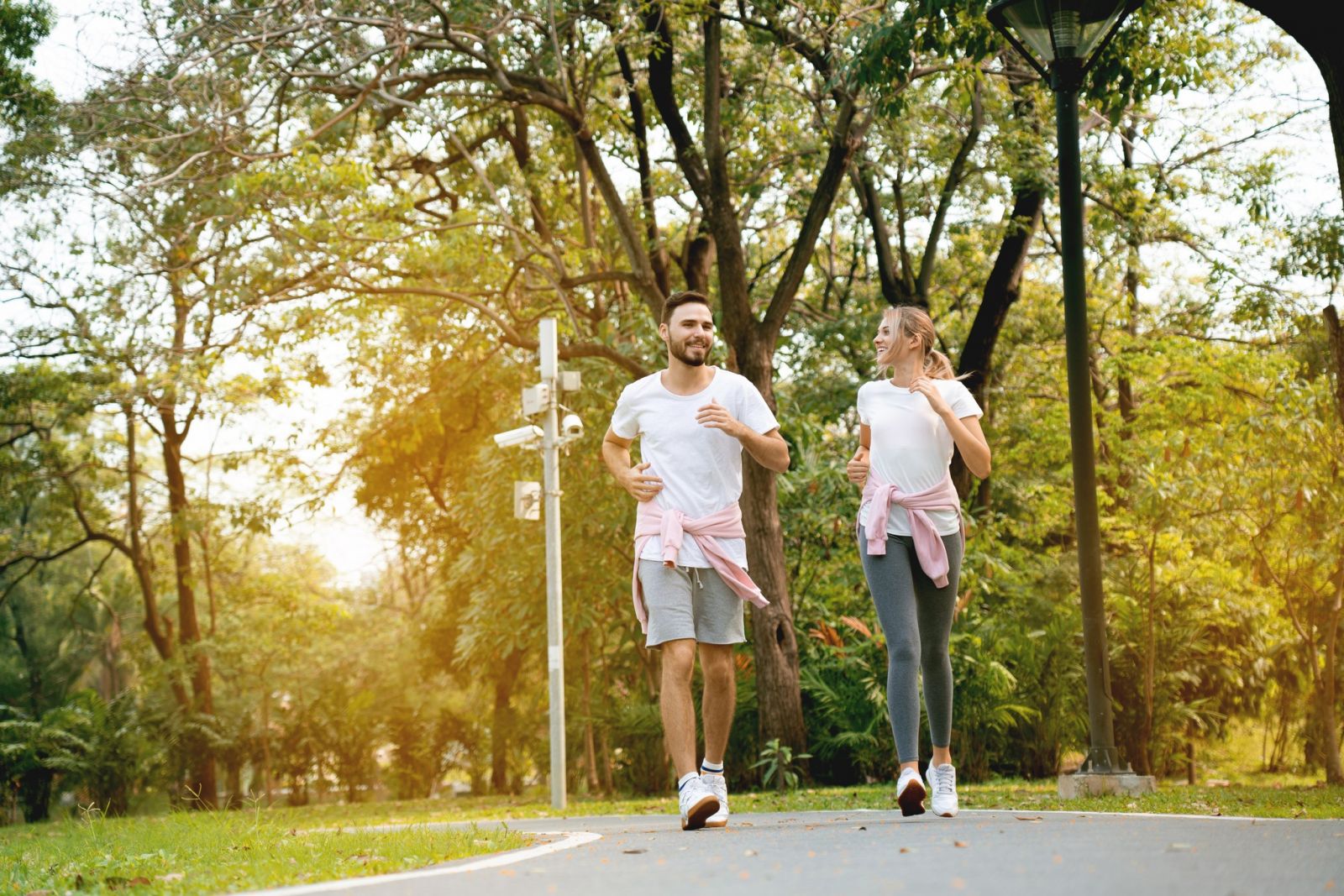 Young happy couple running in a park