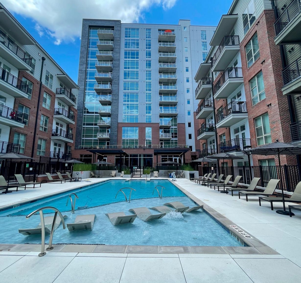 Van Alen apartments with luxury pool in courtyard with surrounding lounge seating