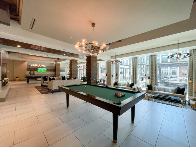 Van Alen apartments resident community lounge with billiards tables and courtyard views