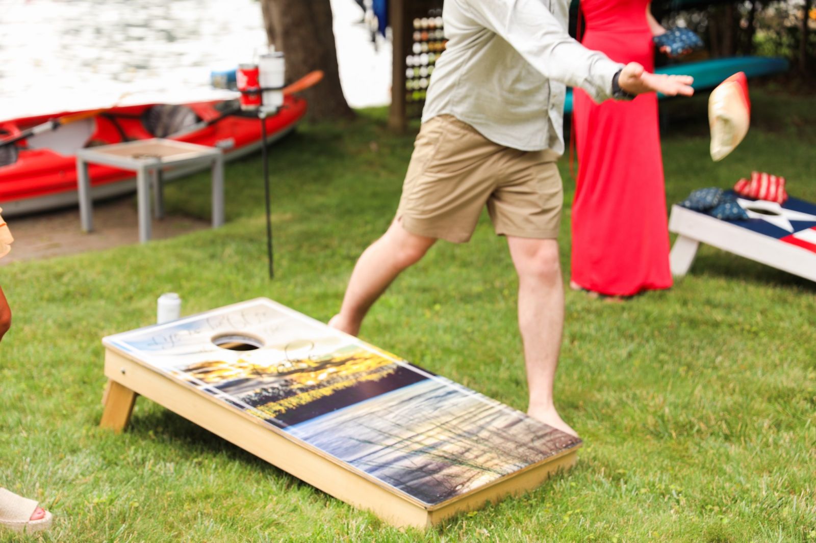 People playing cornhole in a courtyard