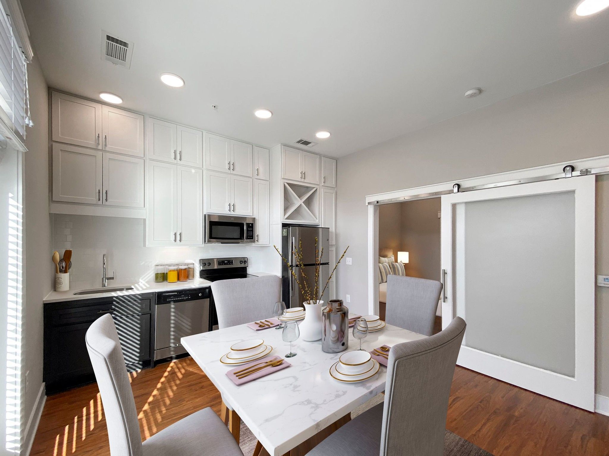 Van Alen apartments in Downtown Durham NC kitchen with custom cabinets and sliding barn door to living room