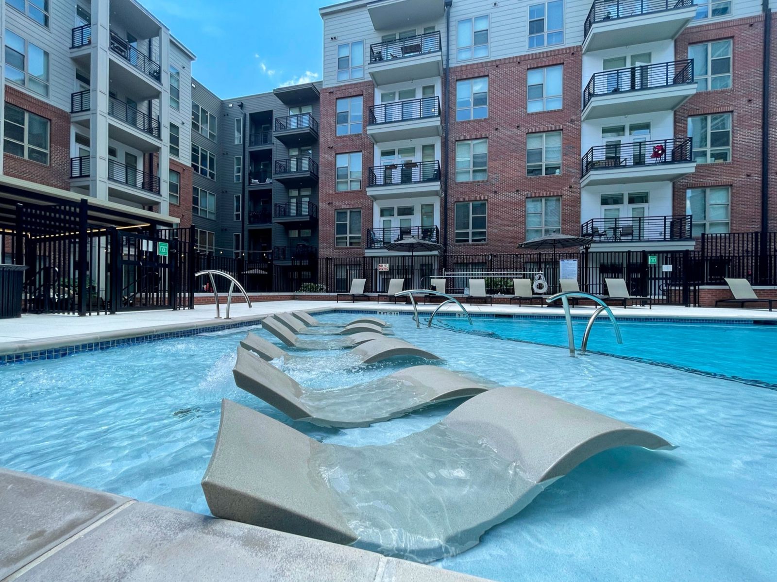 Van Alen apartments resort-inspired pool with in-pool lounge seating