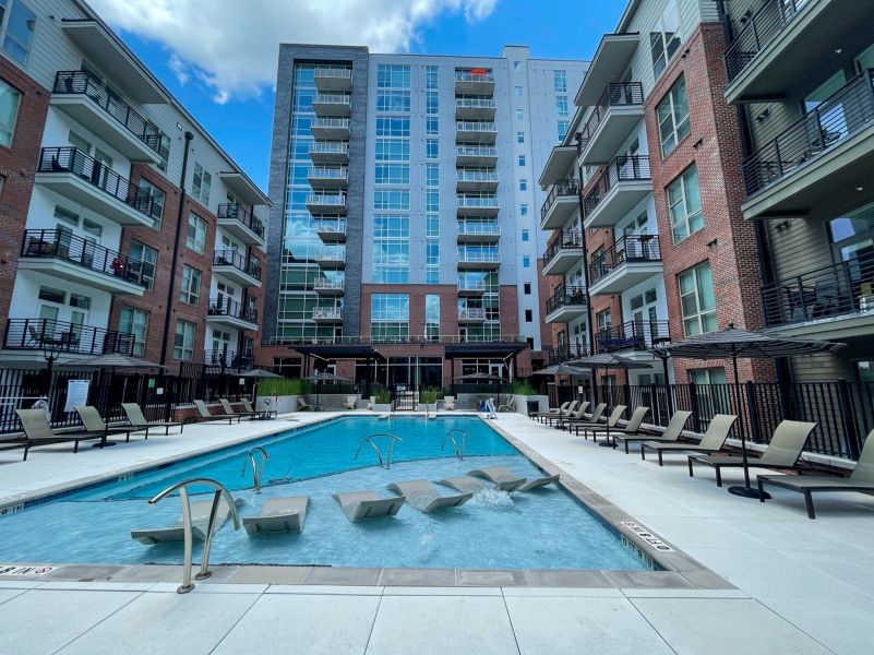 Van Alen apartments with luxury pool in courtyard with surrounding lounge seating