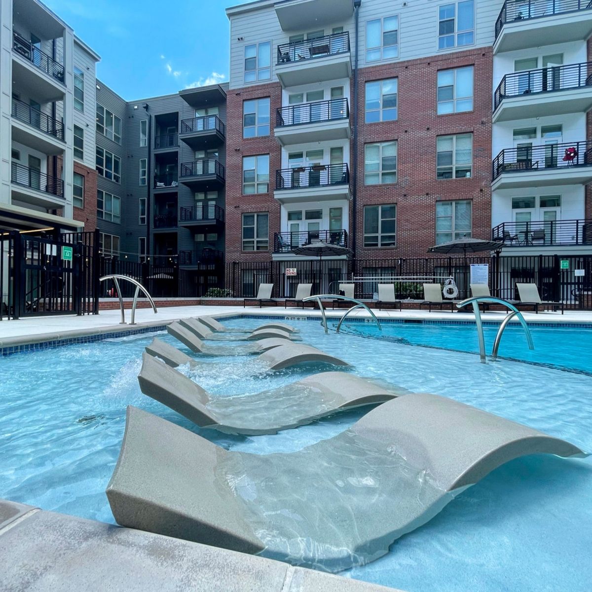 Van Alen apartments resort-inspired pool with in-pool lounge seating