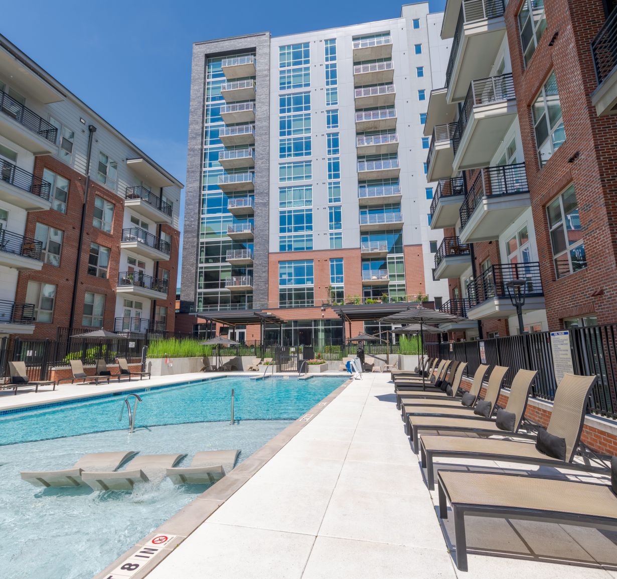Van Alen apartments with luxury pool in courtyard with surrounding lounge seating