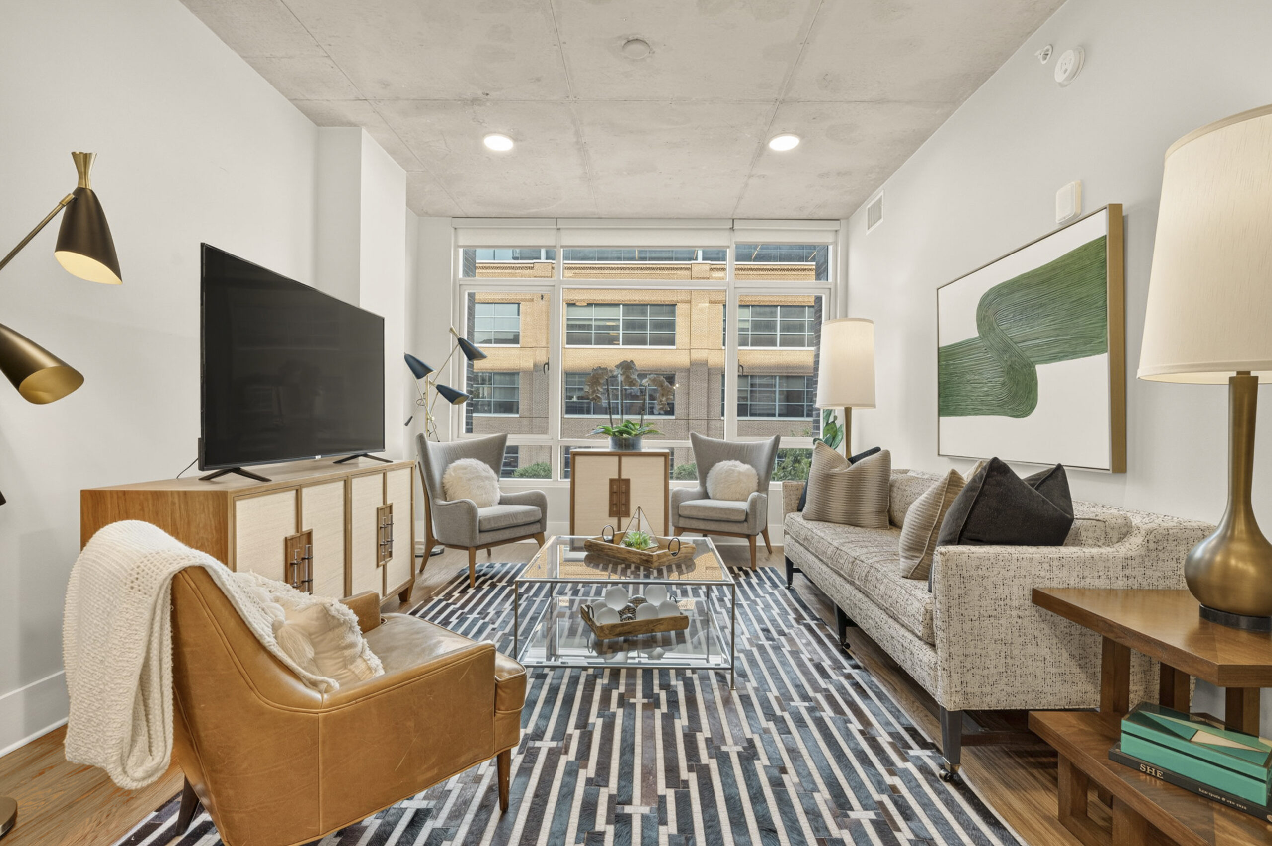 Van Alen apartments in Downtown Durham NC carpeted bedroom with large bed and modern furnishings