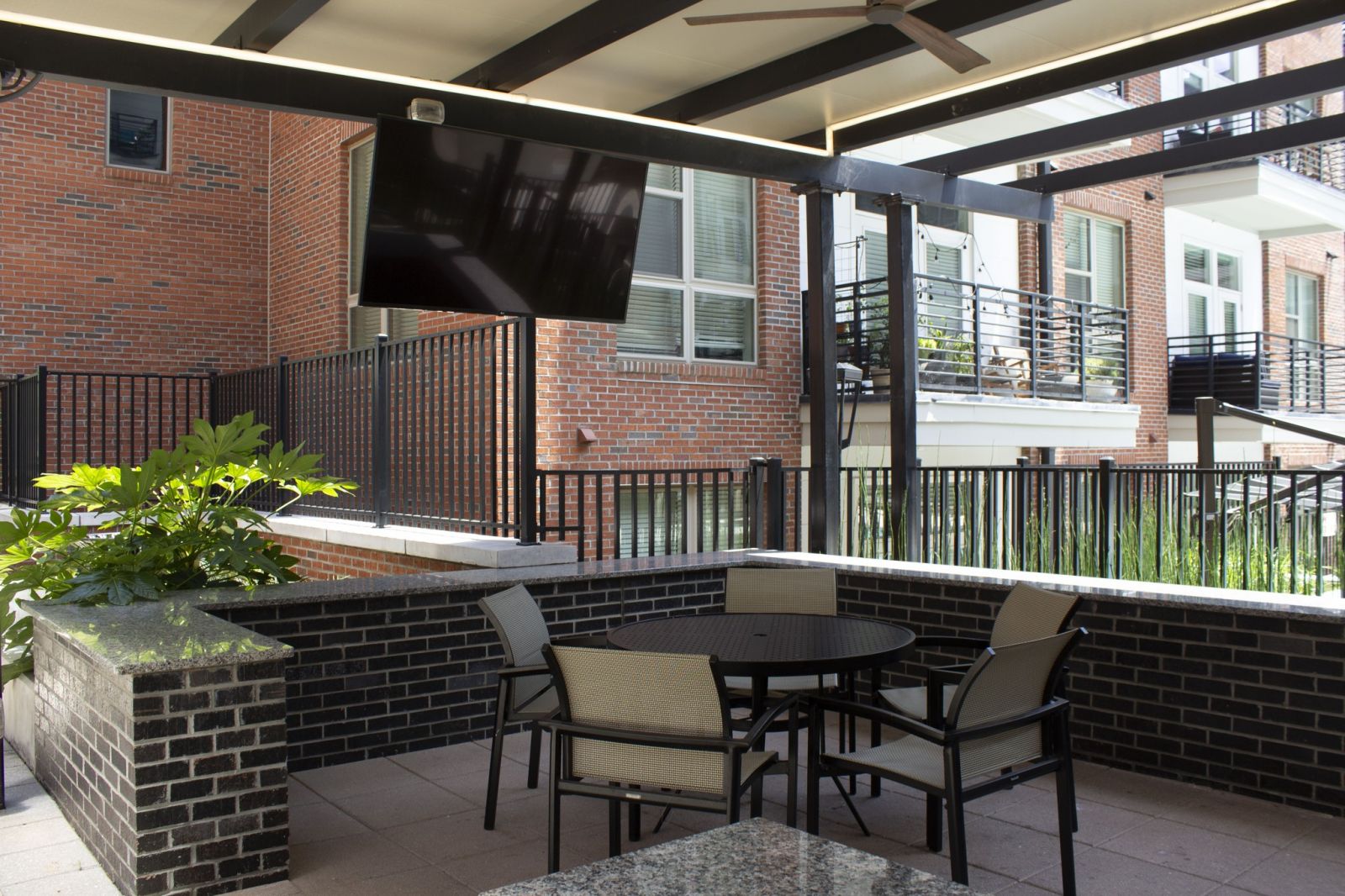 Van Alen community outdoor kitchen pavilion with seating and tv