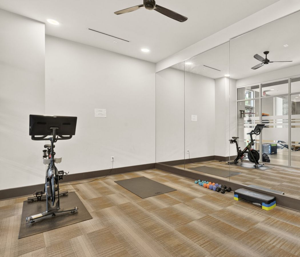 Van Alen apartments resident amenity fitness studio with Peloton bikes and yoga space