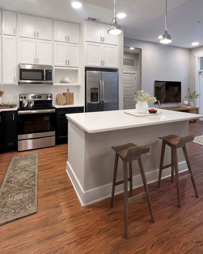 Van Alen apartments in Downtown Durham NC bright kitchen with custom cabinetry, recessed lighting, and kitchen island