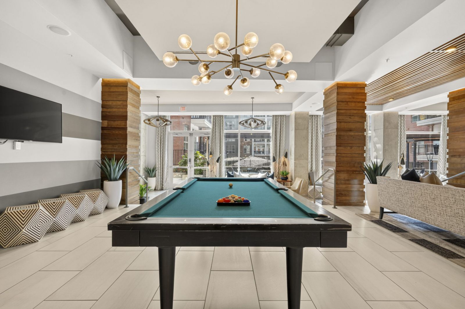 Van Alen apartments resident community lounge with billiards tables and courtyard views
